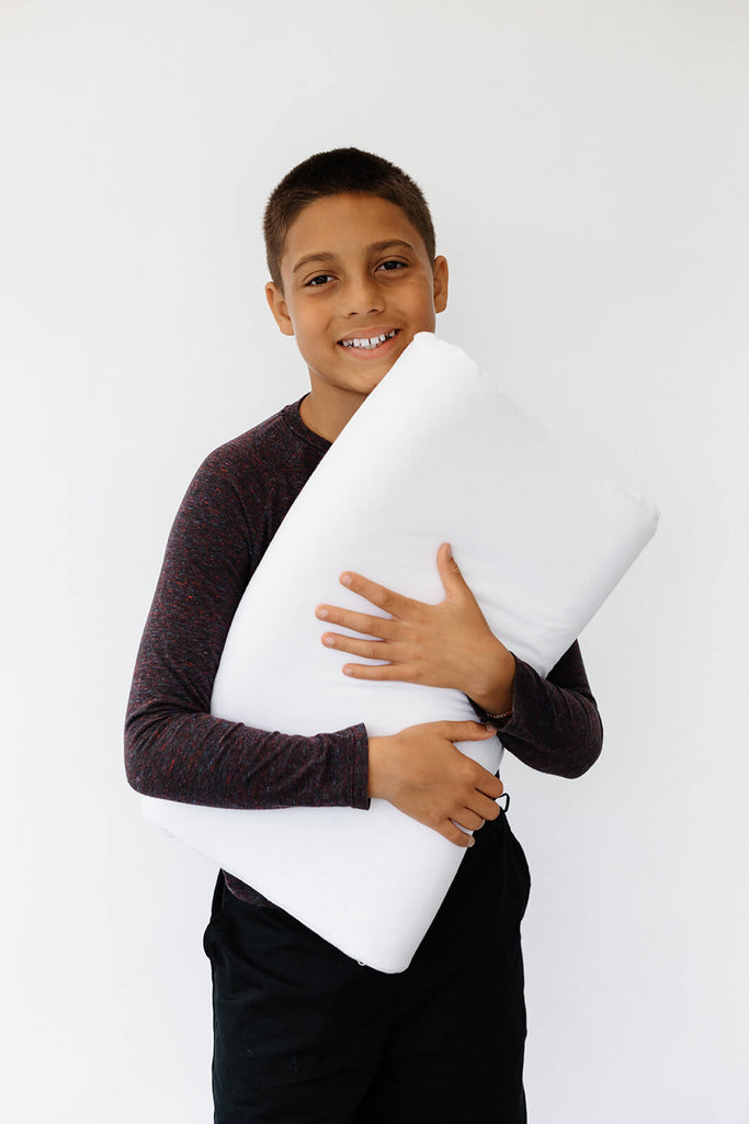 Young boy with a natural latex pillow